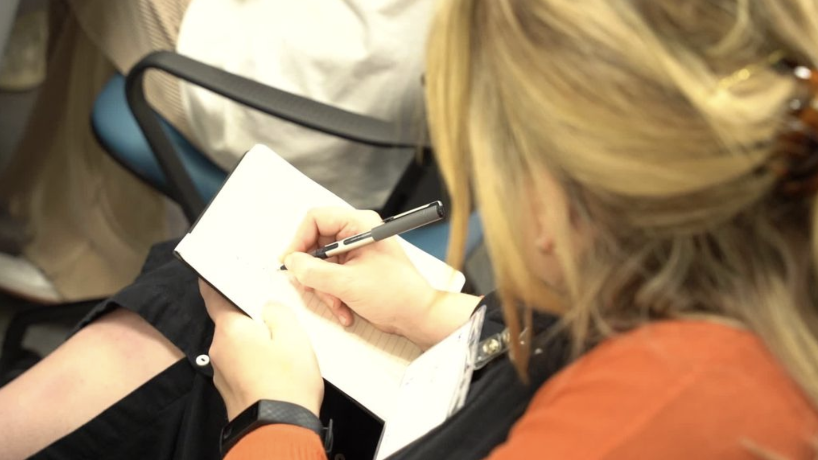 Woman writing in a note pad